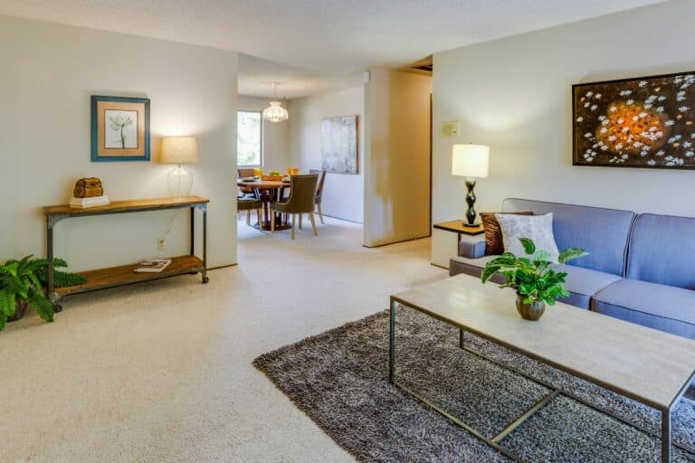 A spacious, well-lit living room and dining area featuring clean furniture arrangements, illustrating a successfully rightsized home.